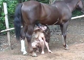 Curly-haired girl puts horse cock in her mouth in an outdoor vid