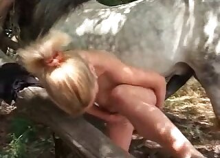 Blond zoophile bends down in front of a horse to get fucked