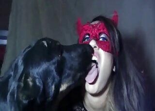 Masked brunette trades licks and kisses with black dog before blowjob