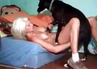 Nude blonde moans while her pussy is getting fucked by a dog's shaft