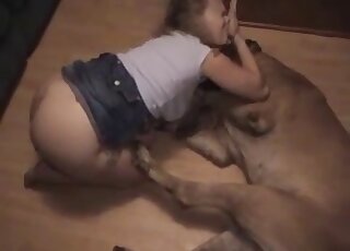 Zoophilic diva in a denim skirt tries to seduce her dog on the floor